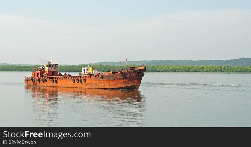 An old rusty ship sailing. An old rusty ship sailing