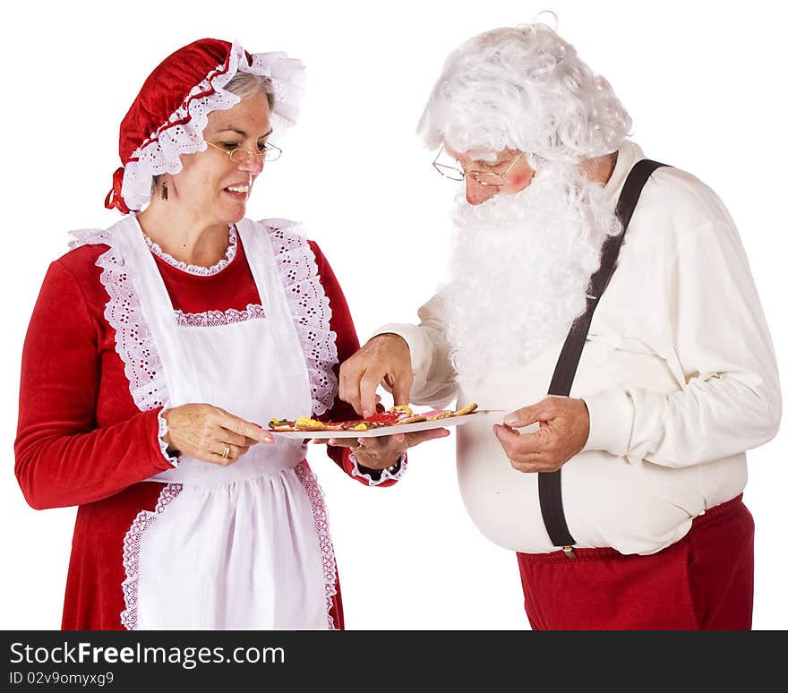 Mrs. Claus serving Christmas cookies to Santa.  Isolated on white. Mrs. Claus serving Christmas cookies to Santa.  Isolated on white.