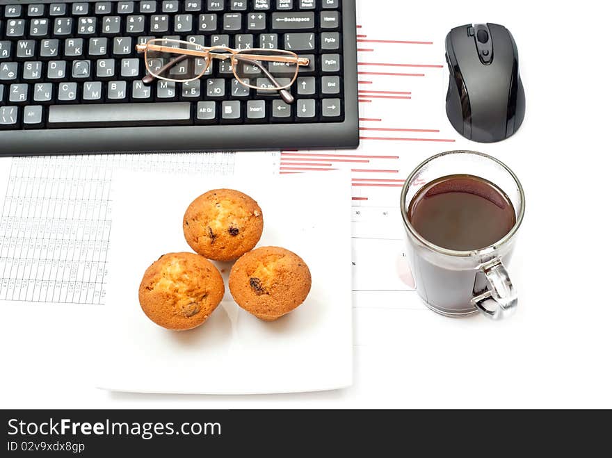 Business still-life with diagrams, glasses, coffee, cake and keyboard. Business still-life with diagrams, glasses, coffee, cake and keyboard