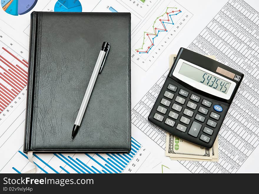 Financial chart with calculator,pen,notebook and money. Financial chart with calculator,pen,notebook and money