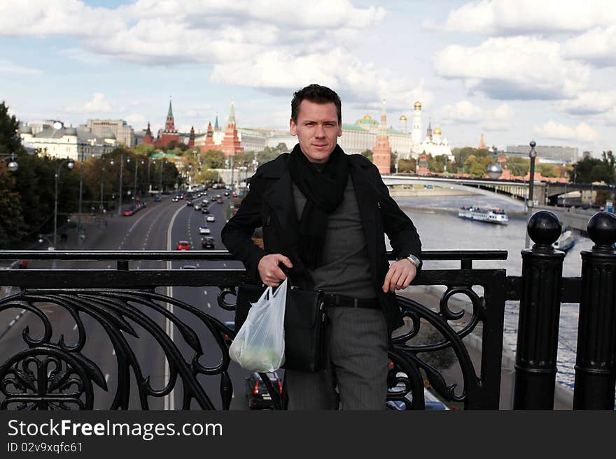 Young man with apples on bridge. Moscow, Russia.