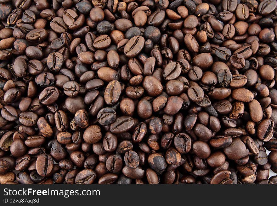 A wallpaper of freshly roasted coffe beans filling the entire screen. A wallpaper of freshly roasted coffe beans filling the entire screen