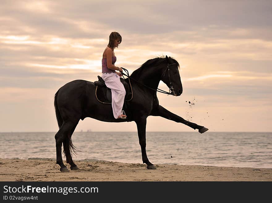 Girl and  horse on the beach