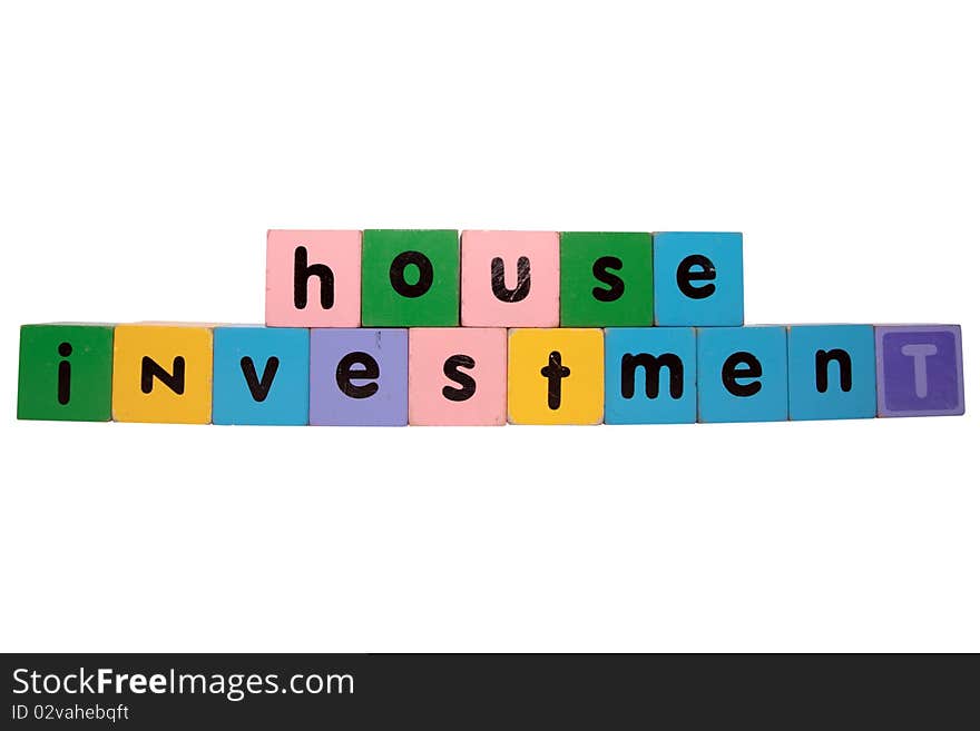 Toy letters that spell house investment against a white background with clipping path. Toy letters that spell house investment against a white background with clipping path