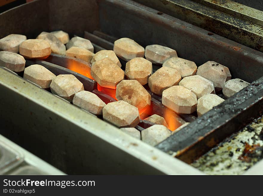 A grill oven with hot stones and fire