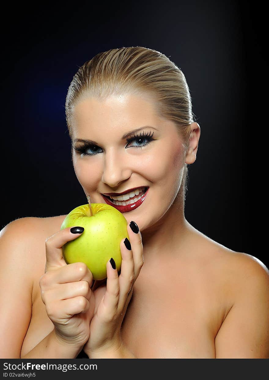 Beautiful woman with bright make-up holding green apple. Beautiful woman with bright make-up holding green apple