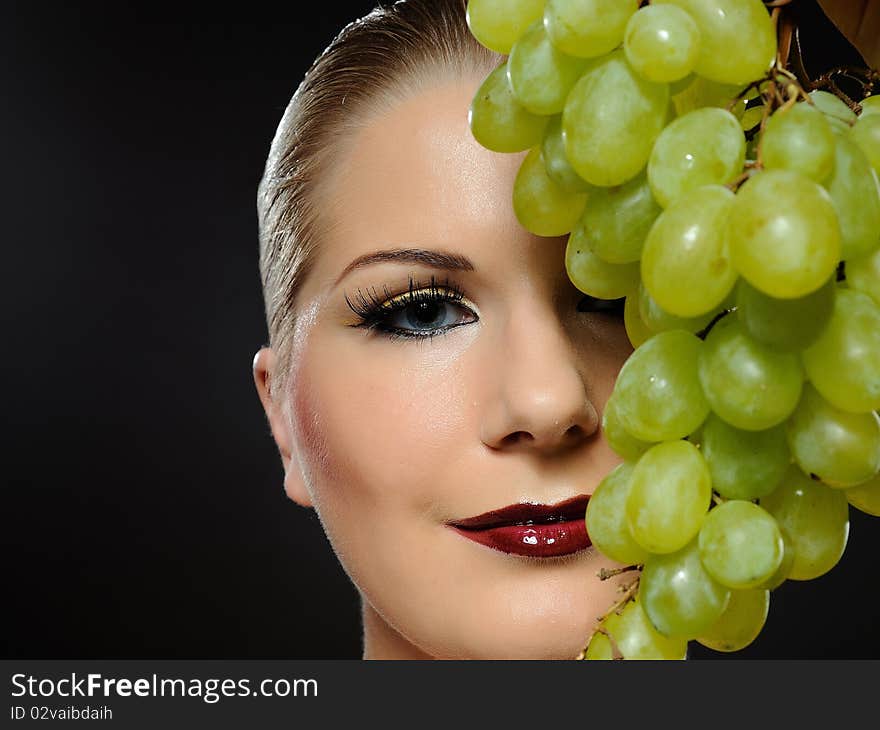 Beautiful woman with white grapes