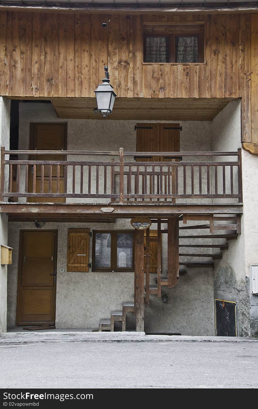 This image shows the front of a log cabin. This image shows the front of a log cabin