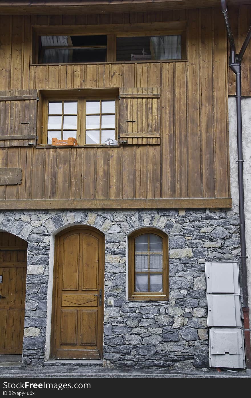 This image shows the front of a log cabin. This image shows the front of a log cabin