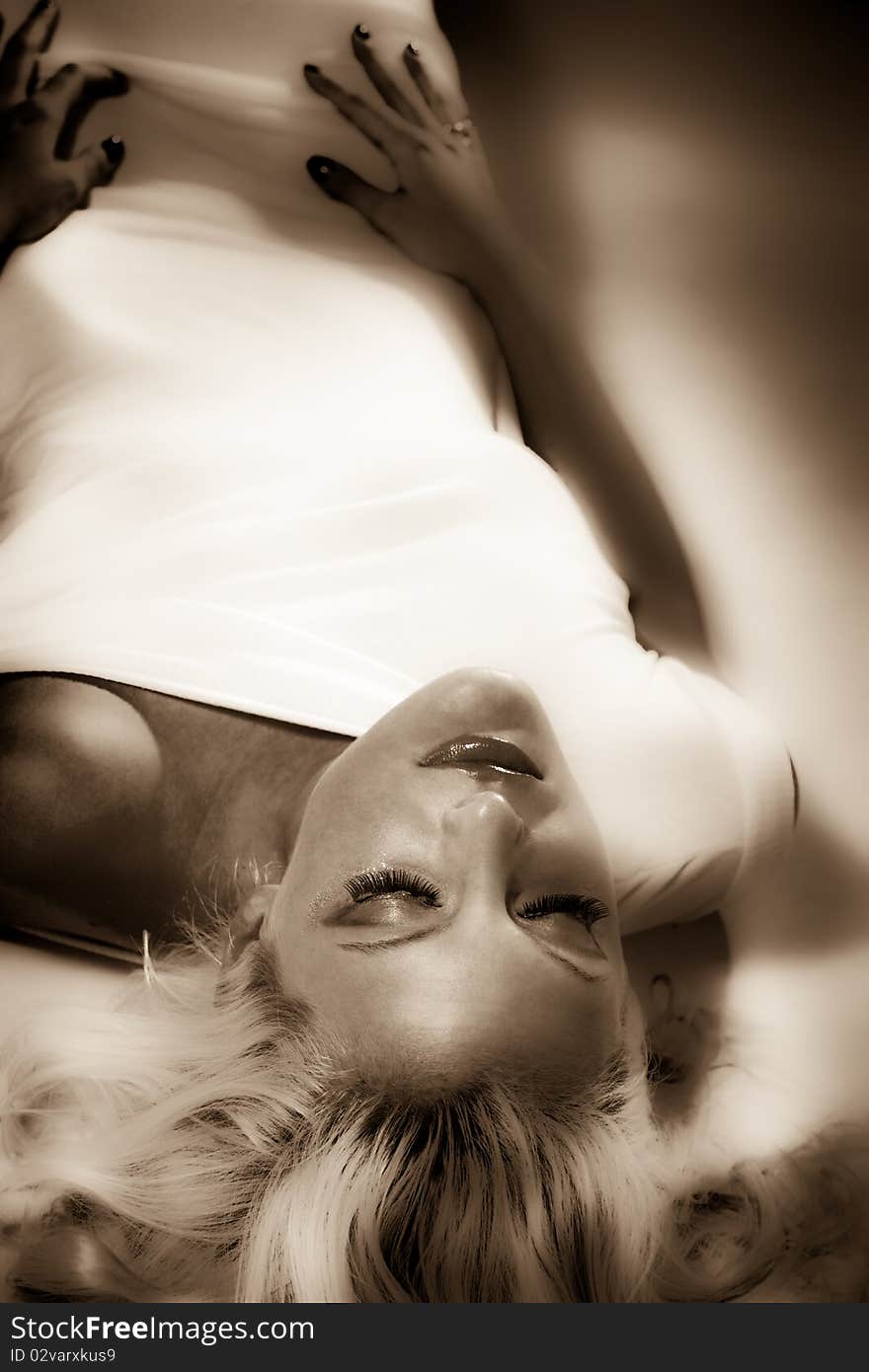 Blond woman in white dress studio shot