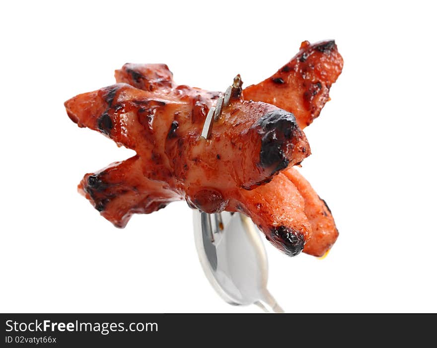 Grilled Sausage on a fork. Isolated on white background.