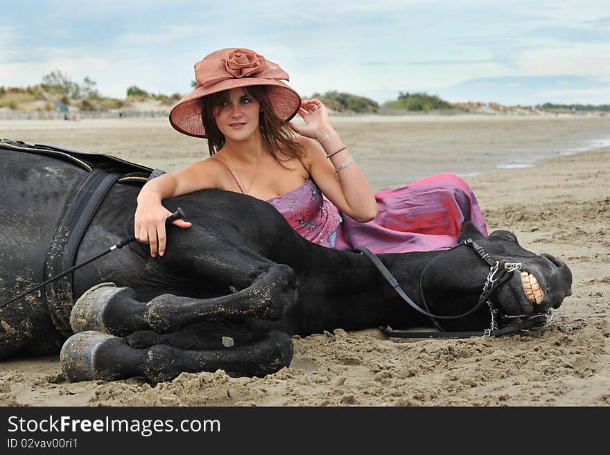 Beautiful black stallion on the beach with young woman. Beautiful black stallion on the beach with young woman