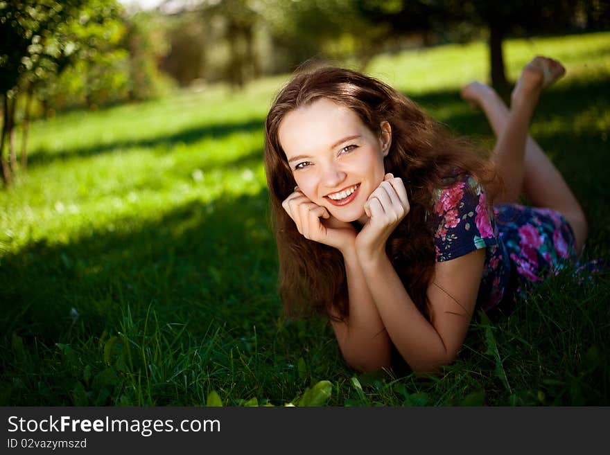 Pretty teenage girl on the grass in the park. Pretty teenage girl on the grass in the park