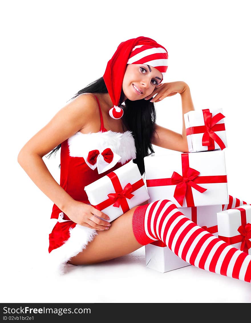 Beautiful young brunette woman dressed as Santa sitting on the floor with a lot of presents. Beautiful young brunette woman dressed as Santa sitting on the floor with a lot of presents