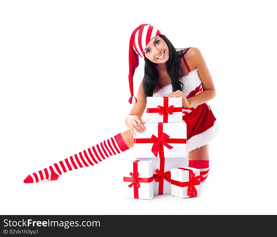 Beautiful young brunette woman dressed as Santa sitting on the floor with a lot of presents. Beautiful young brunette woman dressed as Santa sitting on the floor with a lot of presents