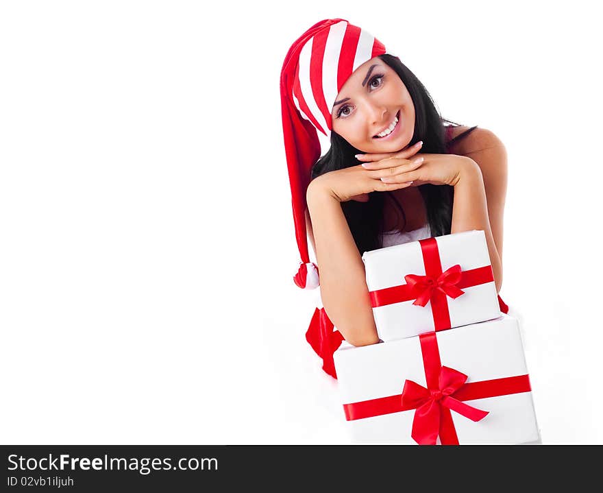 Beautiful young brunette woman dressed as Santa sitting on the floor with a lot of presents. Beautiful young brunette woman dressed as Santa sitting on the floor with a lot of presents