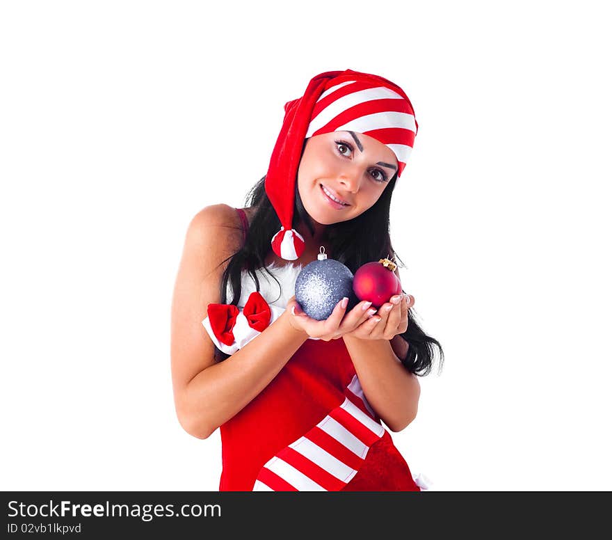 Happy beautiful girl dressed as Santa holding decorations for the fir tree