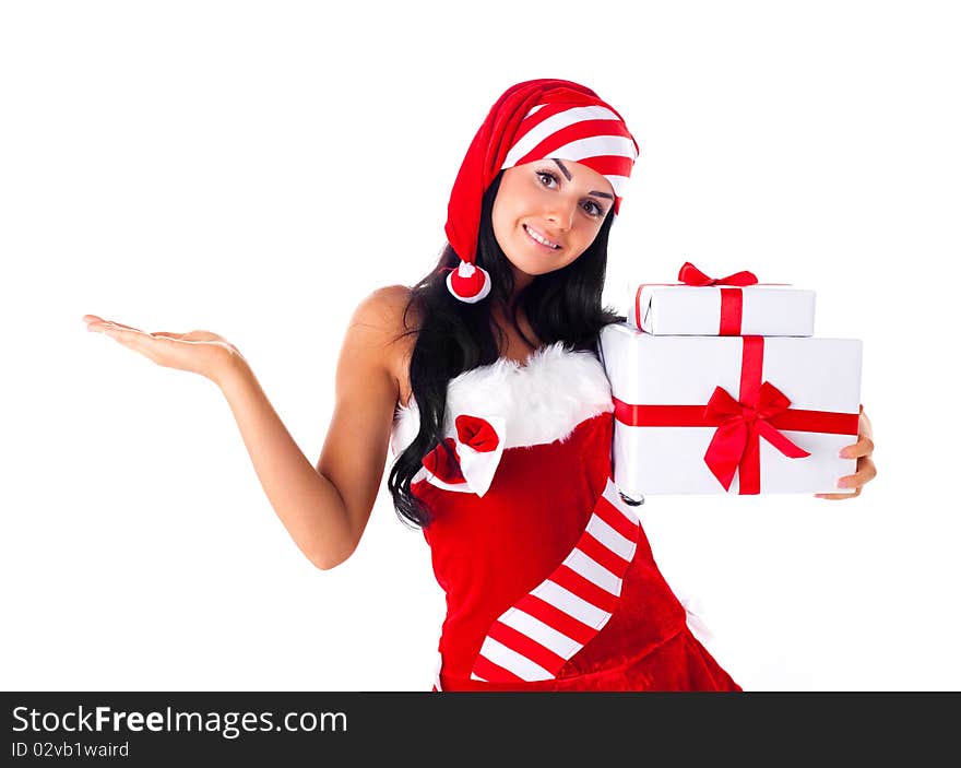 Beautiful young brunette woman dressed as Santa with presents in her hands and her hand up-place your product here. Beautiful young brunette woman dressed as Santa with presents in her hands and her hand up-place your product here