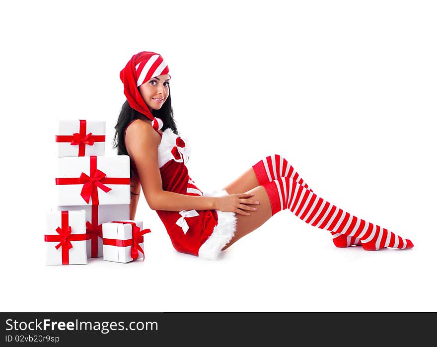 Beautiful young brunette woman dressed as Santa sitting on the floor with a lot of presents. Beautiful young brunette woman dressed as Santa sitting on the floor with a lot of presents