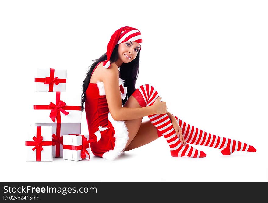 Beautiful young brunette woman dressed as Santa sitting on the floor with a lot of presents. Beautiful young brunette woman dressed as Santa sitting on the floor with a lot of presents