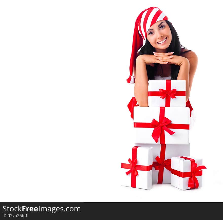 Beautiful young brunette woman dressed as Santa sitting on the floor with a lot of presents. Beautiful young brunette woman dressed as Santa sitting on the floor with a lot of presents