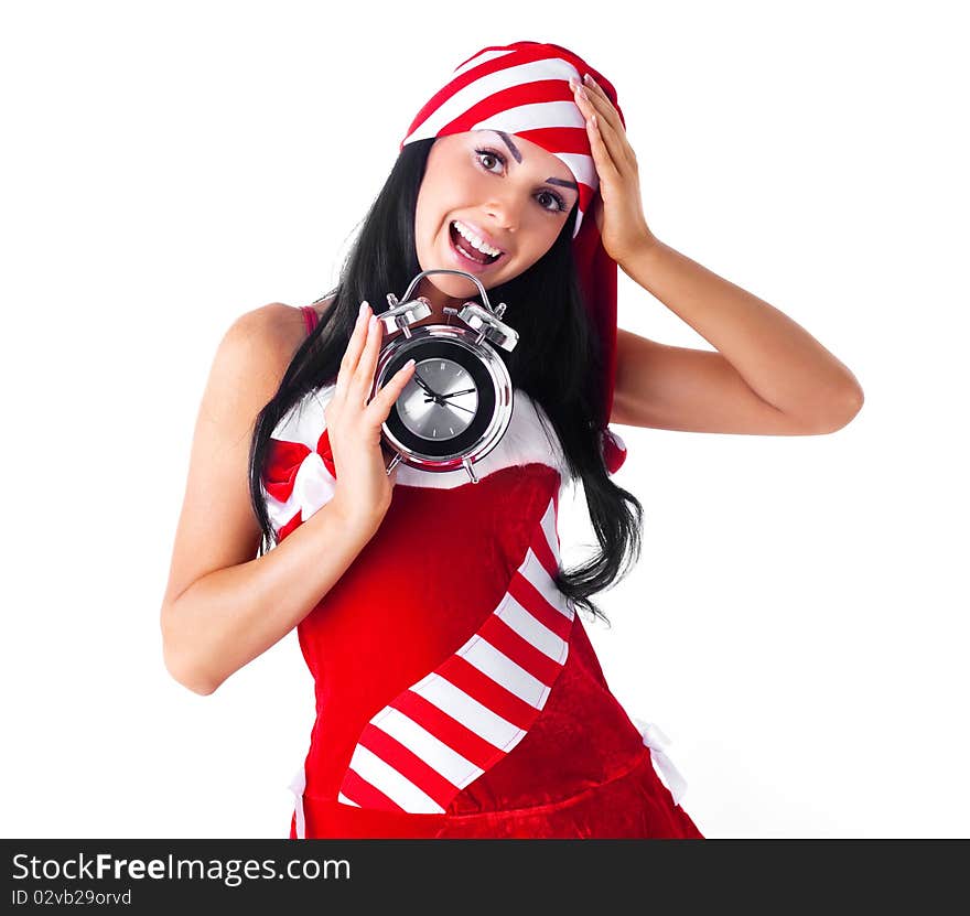 Shocked young brunette woman dressed as Santa with an alarm clock. Shocked young brunette woman dressed as Santa with an alarm clock