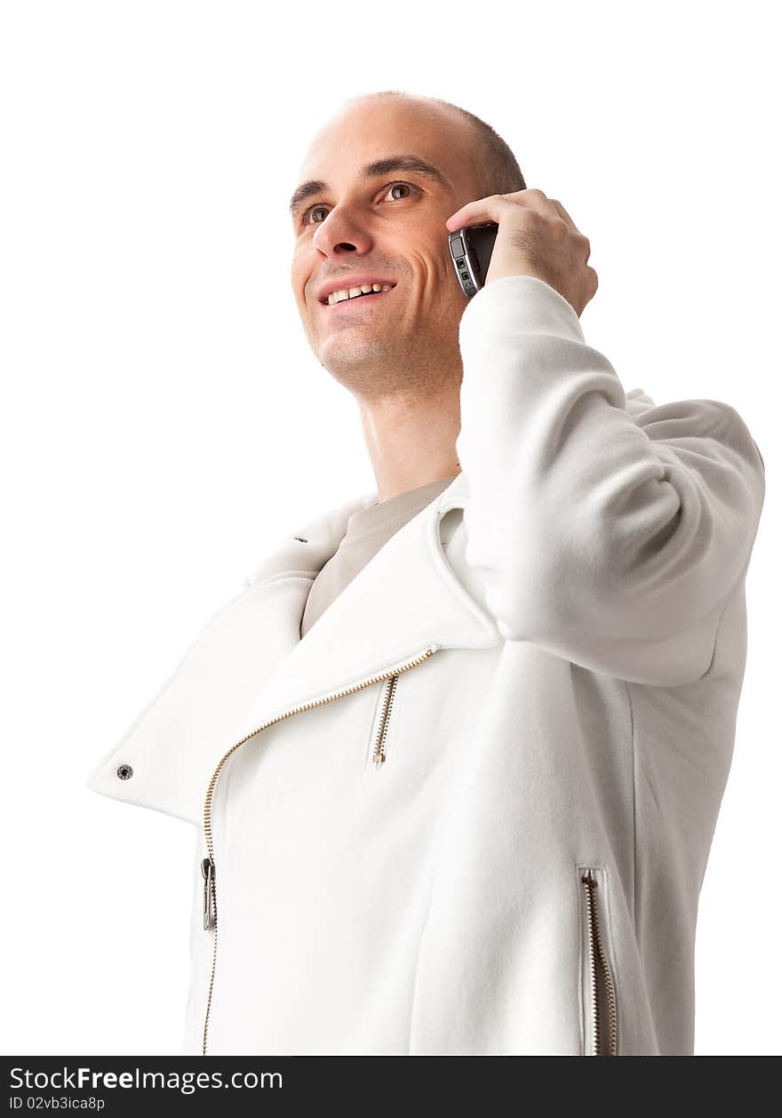 Happy young guy speaking on cellphone isolated on white background