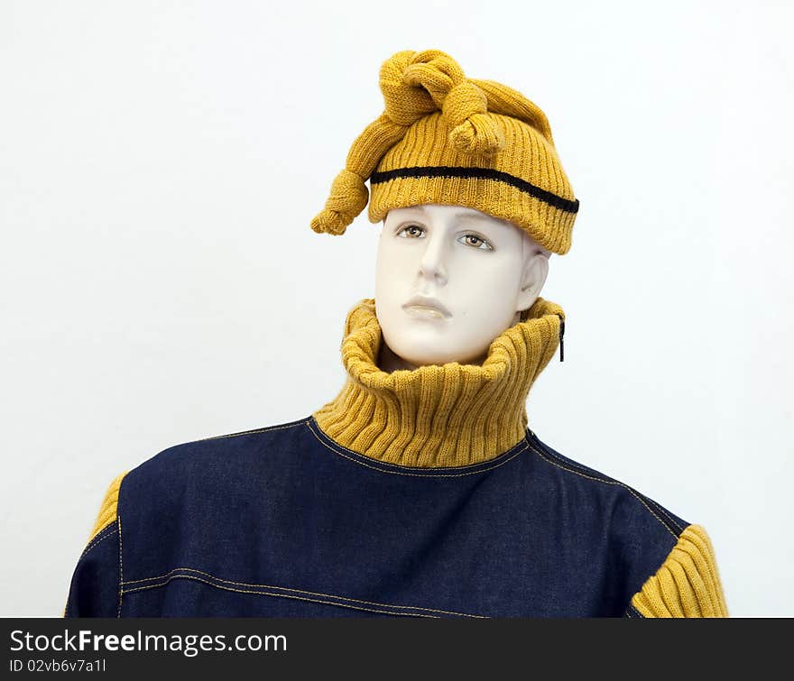 Head and torso of a male mannequin in fashion clothes - woolly hat and jumper.