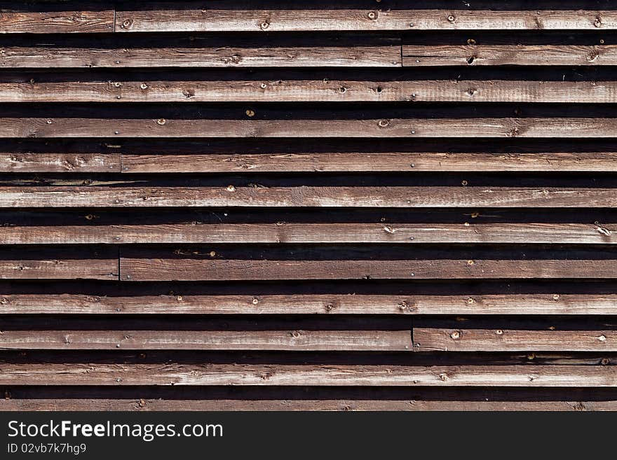 Natural colored wooden fence around industrial area. Natural colored wooden fence around industrial area