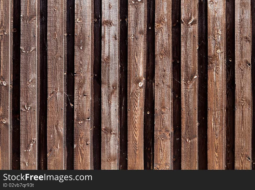 Natural colored wooden fence around industrial area