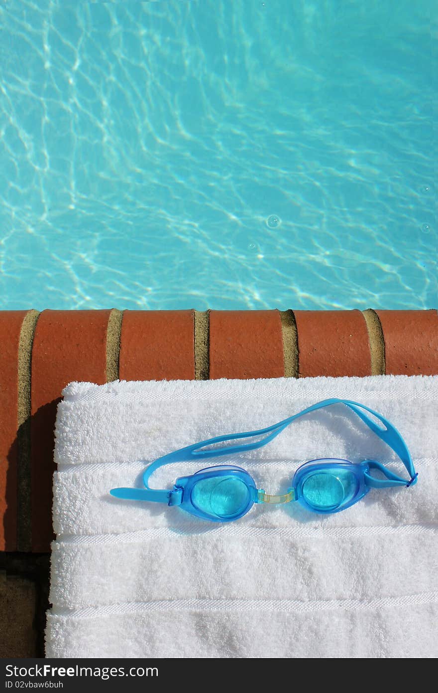 Goggles at the edge of a swimming pool