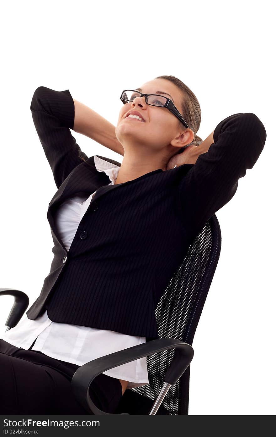 A business woman leaning back in a black chair dreaming. A business woman leaning back in a black chair dreaming