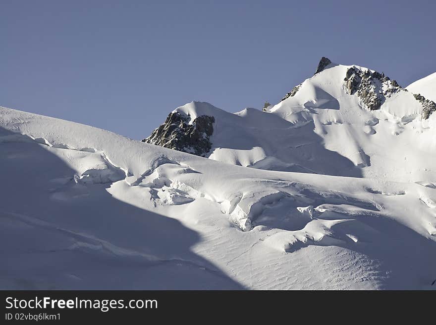 From the top of l'Aiguille du Midi (3842 m), the views of the Alps are spectacular. In this picture you can see one of the paths that lead to the summit of Mont-Blanc. Top right, you can see the Mont Maudit, near the Mont-Blanc, seen from l'Aiguille du Midi. From the top of l'Aiguille du Midi (3842 m), the views of the Alps are spectacular. In this picture you can see one of the paths that lead to the summit of Mont-Blanc. Top right, you can see the Mont Maudit, near the Mont-Blanc, seen from l'Aiguille du Midi.