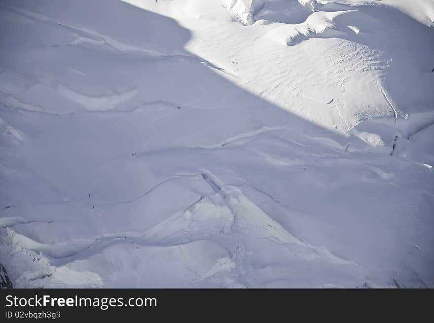 From the summit of l'Aiguille du Midi (3,842 m), the views of the Alps are spectacular. In this picture you can see the Mont-Blanc. In this picture you can see the cracks open the ice, as well as the path opened by the climbers in their ascent to the summit of Mont Blanc. From the summit of l'Aiguille du Midi (3,842 m), the views of the Alps are spectacular. In this picture you can see the Mont-Blanc. In this picture you can see the cracks open the ice, as well as the path opened by the climbers in their ascent to the summit of Mont Blanc