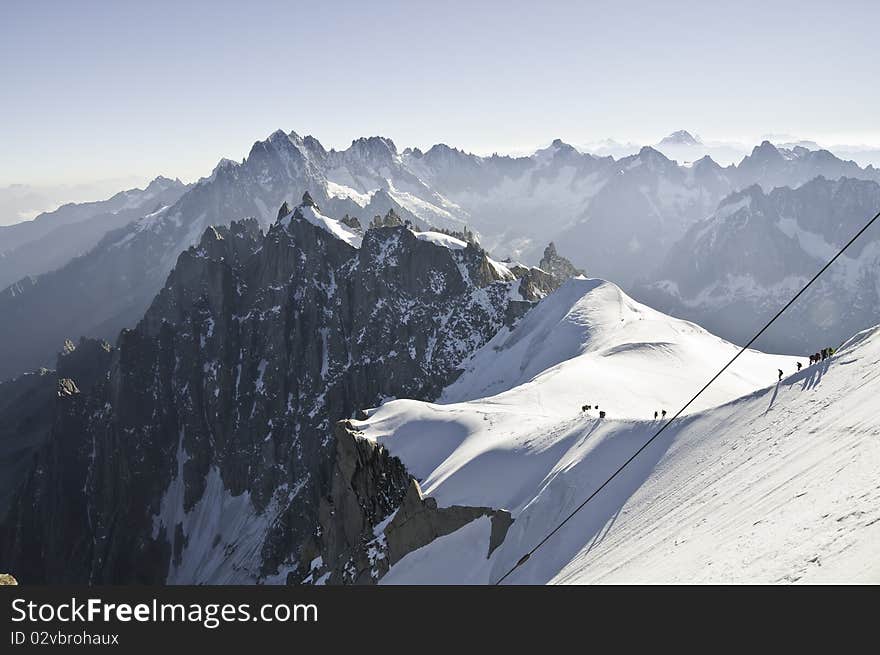 From the summit of l'Aiguille du Midi (3,842 m), the views of the Alps are spectacular. Descent of the climbers from l'Aiguille du Midi, to the Plan du Midi, much more below. From the summit of l'Aiguille du Midi (3,842 m), the views of the Alps are spectacular. Descent of the climbers from l'Aiguille du Midi, to the Plan du Midi, much more below.