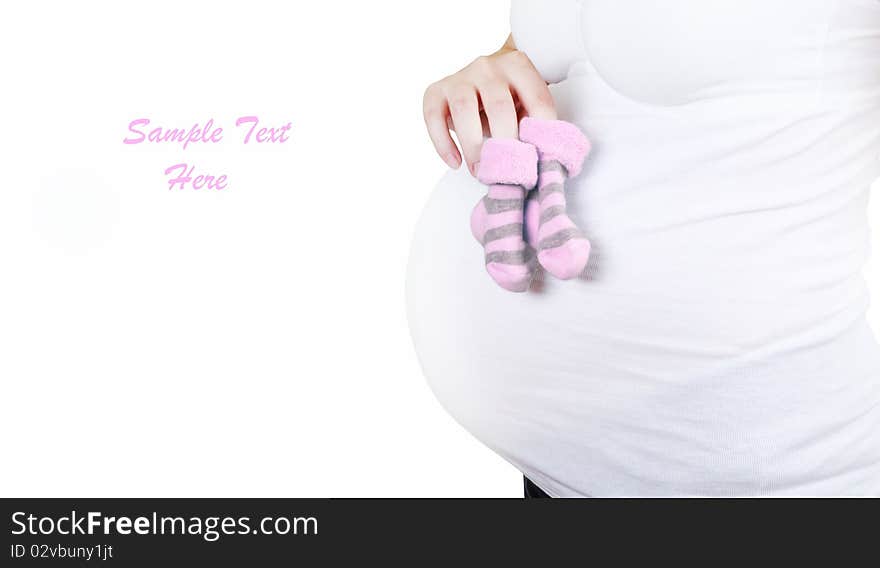 A pregnant woman with striped pink baby socks. A pregnant woman with striped pink baby socks