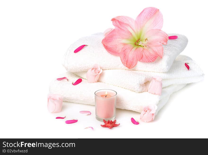 White towels with pink soap roses and candle on white background. White towels with pink soap roses and candle on white background