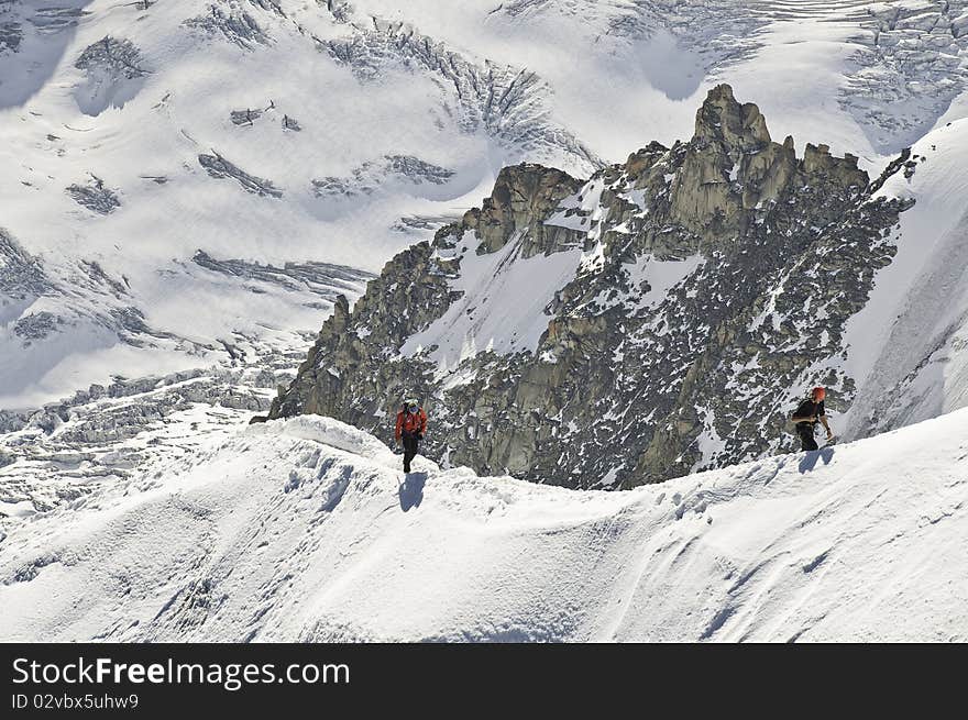 From the summit of l'Aiguille du Midi (3,842 m), the views of the Alps are spectacular. In this picture, you can see the descent of the mountain, along the ridge. From the summit of l'Aiguille du Midi (3,842 m), the views of the Alps are spectacular. In this picture, you can see the descent of the mountain, along the ridge.