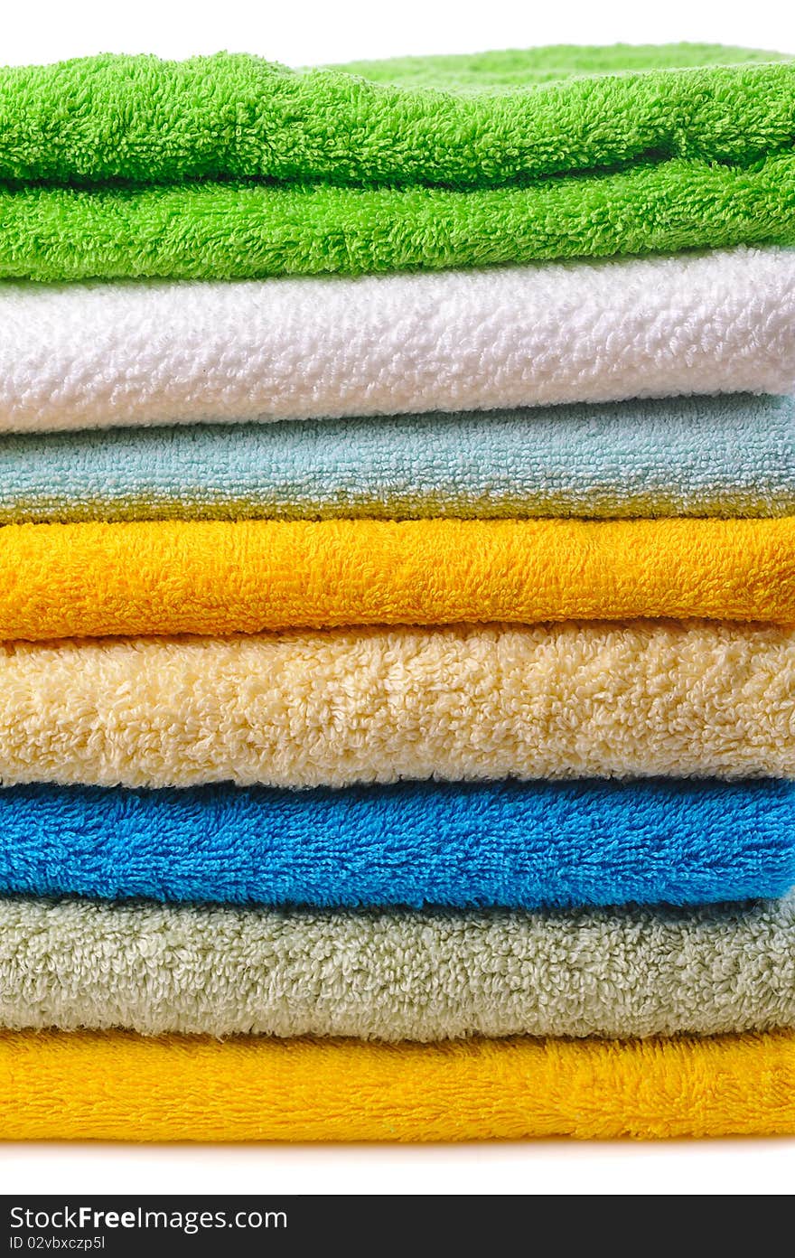 Stack of colorful towels isolated on white. Stack of colorful towels isolated on white