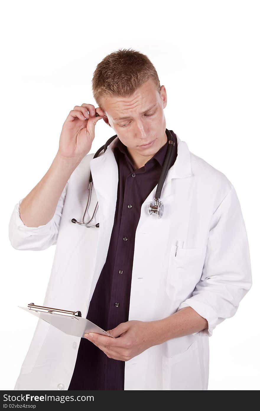 A male doctor looking at his chart with a serious expression on his face. A male doctor looking at his chart with a serious expression on his face.