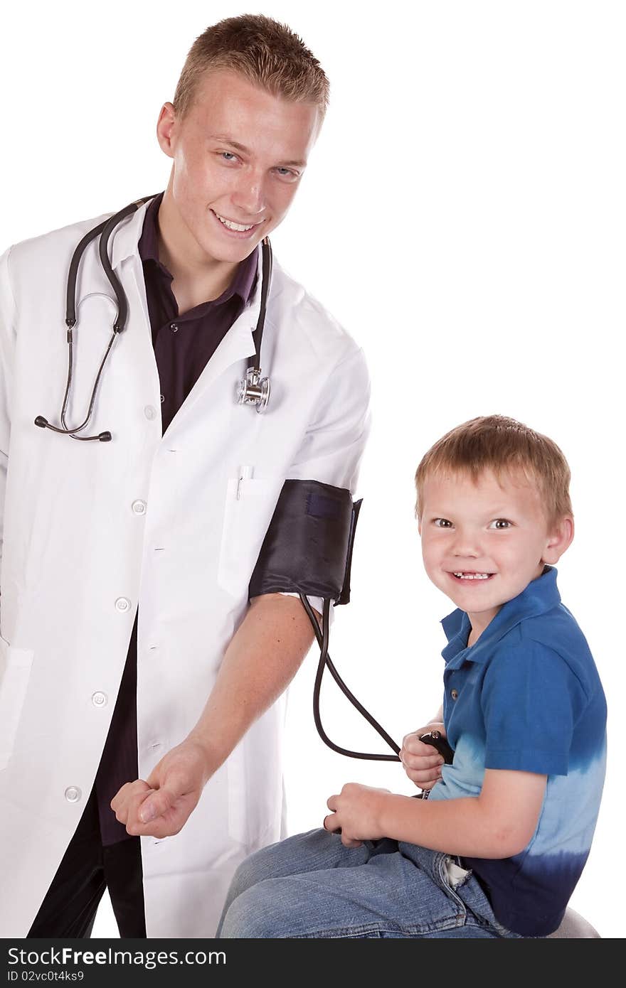 A male doctor letting his young boy patient check his blood pressure. A male doctor letting his young boy patient check his blood pressure.