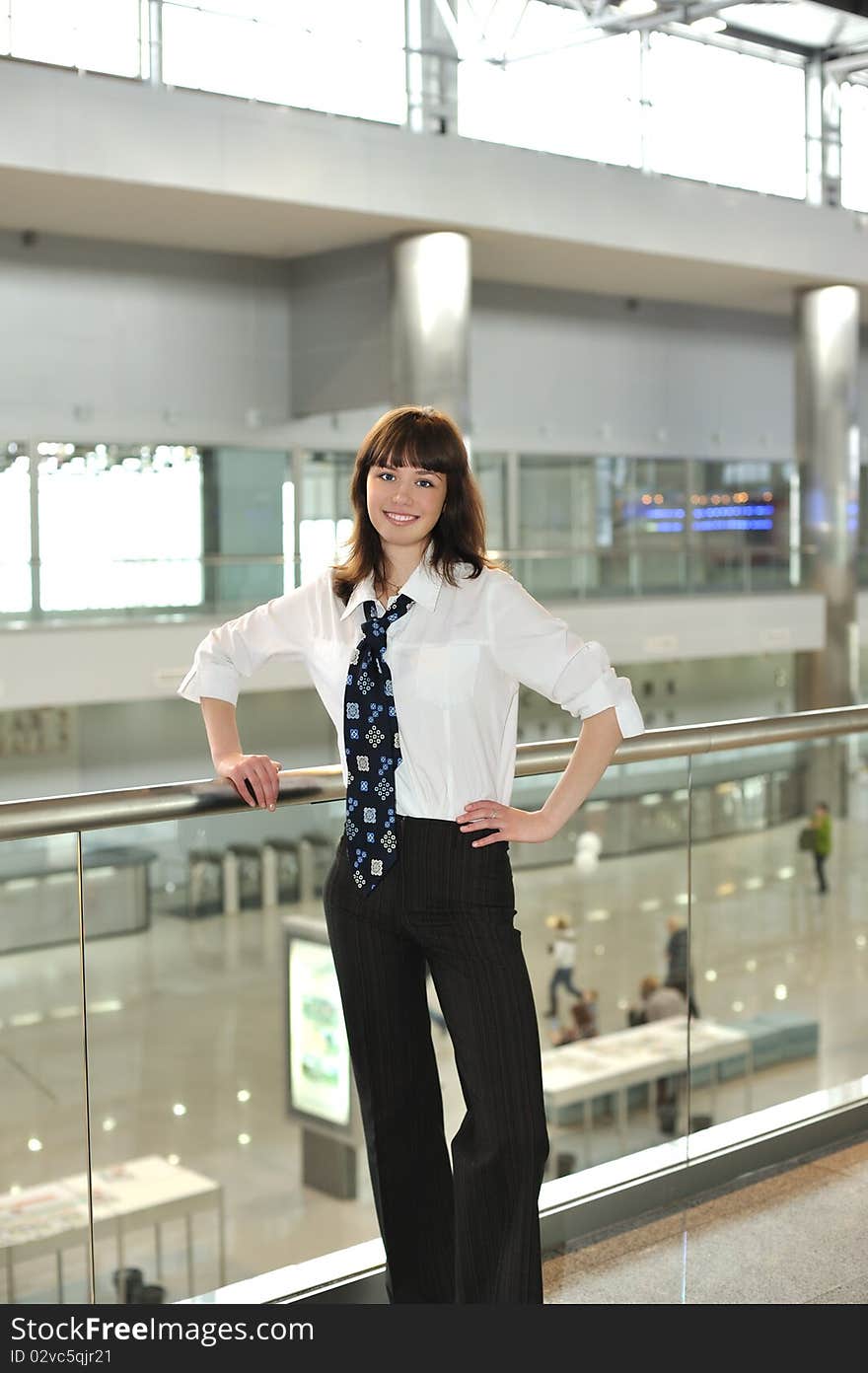 Business young woman standing in office environment. Business young woman standing in office environment