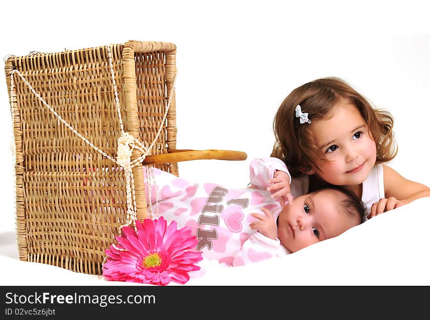 Two sisters playing and smiling in a basket