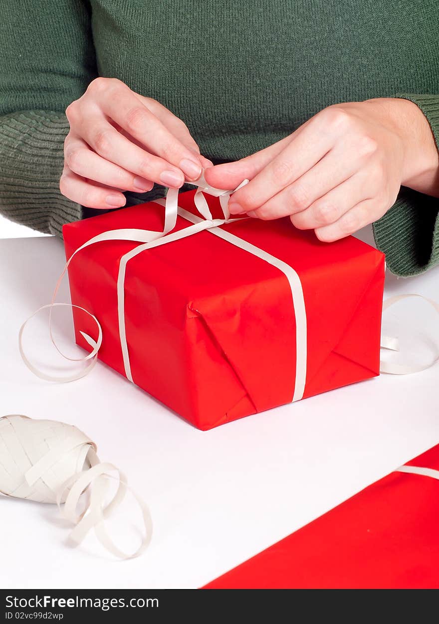 Women wrapping red gitf box