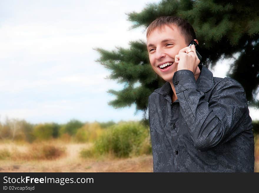 Portrait of casual young man talking on cellphone. Portrait of casual young man talking on cellphone