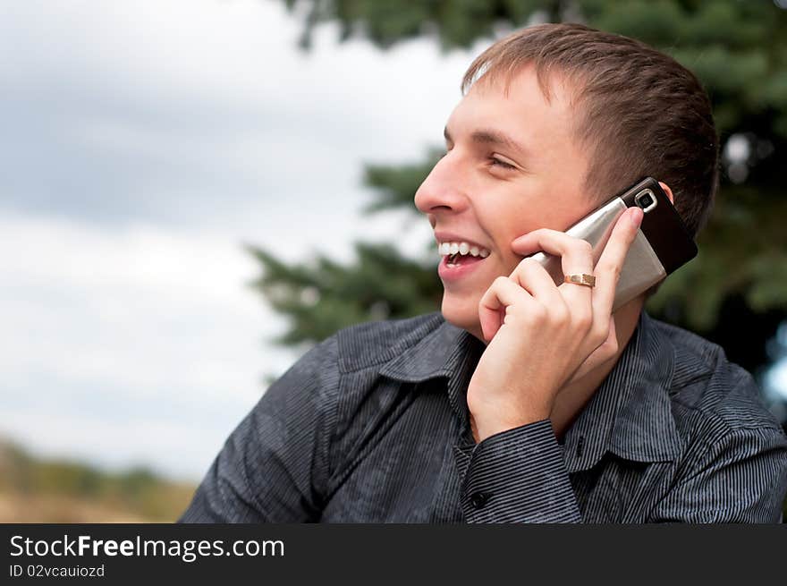 Portrait of casual young man talking on cellphone. Portrait of casual young man talking on cellphone