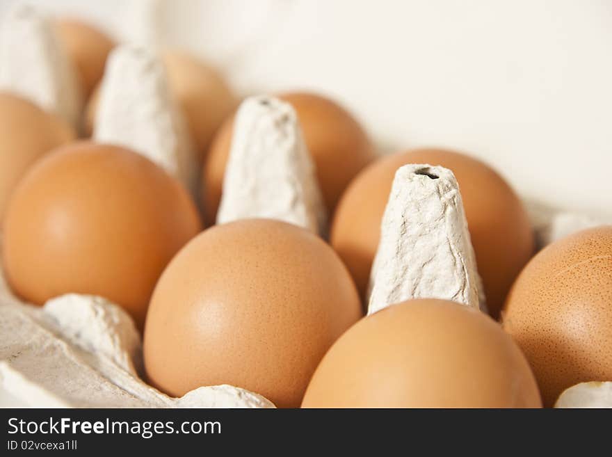 Row of fresh eggs in a box