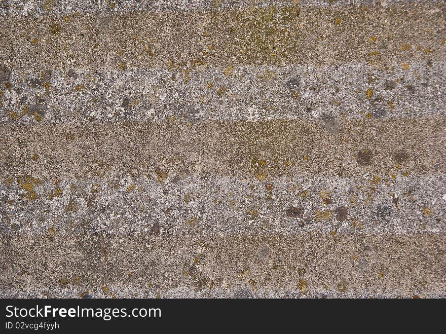 Stone wall used as a wall of a house of great old building in the background