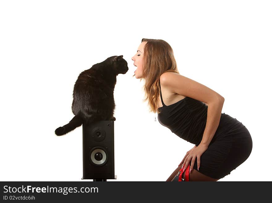 A black cat looks into the girls mouth. A black cat looks into the girls mouth