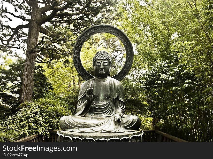 An aged Buddha statue rests quietly in the forest. An aged Buddha statue rests quietly in the forest.